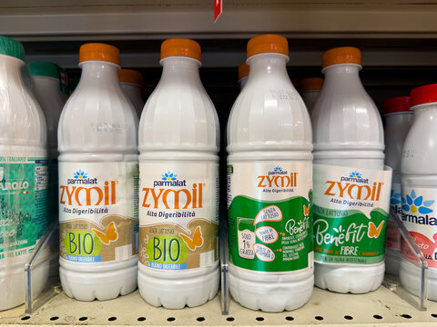 CALABRIA, ITALY - JUNE 4, 2025 - Several Parmalat Zymil milk bottles, both bio and with fiber, are arranged on a supermarket shelf, ready for purchase