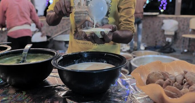 Indian caterers preparing delicious chat, panipuri, and patis at a festive event, showcasing vibrant flavors and traditional street food culture