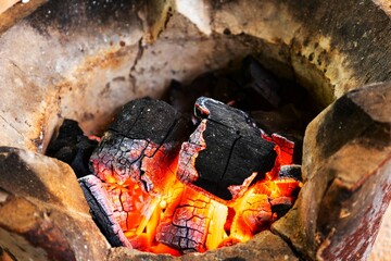Glowing Charcoal Embers with Flames  and  Fire Heat Background for BBQ concept idea