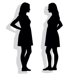 Silhouettes of two women standing in profile with shadows  