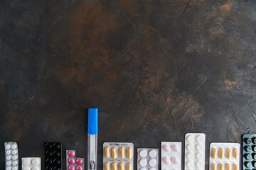 Pills capsules medicine health on dark background top view, medical pharmacy concept. Different pills on dark background with copy space.