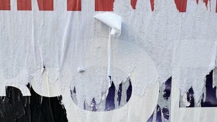 Torn street posters creating abstract urban textures with film grain