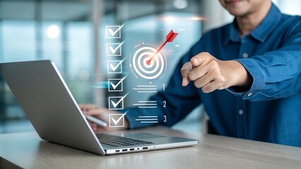 Businessman Using Laptop with Target Graphic for Goal Tracking