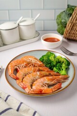 Boiled shrimp with Broccoli in ceramic plate on white background, clean meals