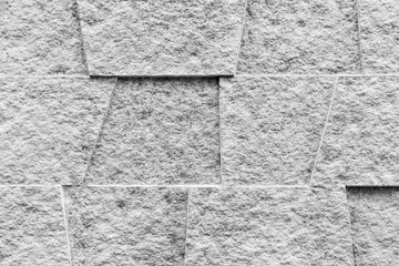 White concrete slabs are arranged in an alternating convex and concave pattern for background or...