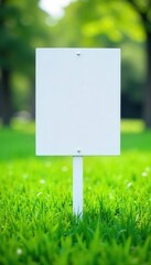 Crisp white sign contrasts vibrant green grass, fresh, marketing, real estate