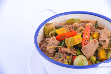 Thai favorite food. Spicy chicken soup (Tom Yum Gai Baan) in the white bowl.