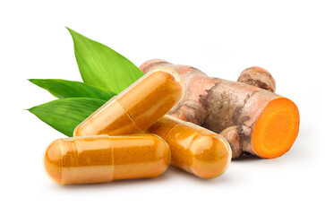 Turmeric capsules with fresh rhizome isolated on white.