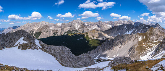 Stunning panorama view of the Tyrolean Alps massif from top of Hafelekarspitze peak in spring on a sunny day with blue sky, Innsbruck, Tyrol, Austria