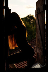 girl posing in the doorway at sunset