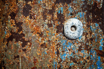 close up of rusty metal surface with erosion an peeling paint