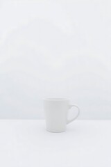 Minimalist composition featuring white mug on a white plain background