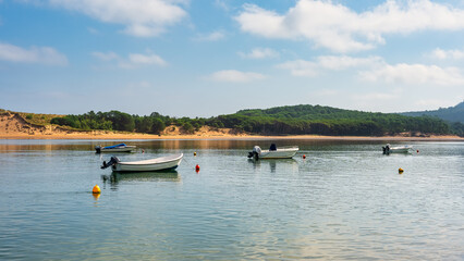 Small boats anchored in the Mogro estuary in northern Spain, Cantabria, Santander.