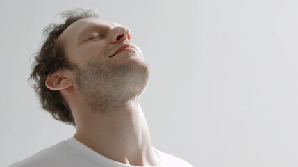 Naklejka premium A man feeling relief, exhaling deeply, eyes closed, shoulders relaxed, clean white studio setup