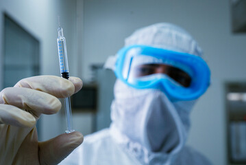 isolated injection syringe close up. person holding a pre filled syringe. injection syringe in...