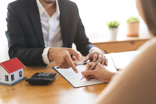 Asian landlord calculate price, client or tenant hand sign contract rental purchase buyer home with landlord, realtor after banker agreement mortgage, loan success done. Property lease agent concept.