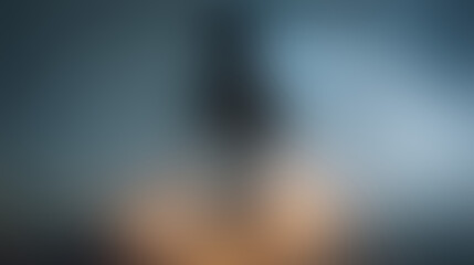 Abstract Blurred Background with Soft Blue-Grey and Warm Orange Hues: Defocused, Bokeh, and Gradient Concept
