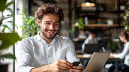 Fototapeta premium Happy Young Man Using Smartphone in Modern Office Environment