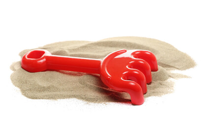 Plastic red rake, beach toy for kids in sand, isolated on white background