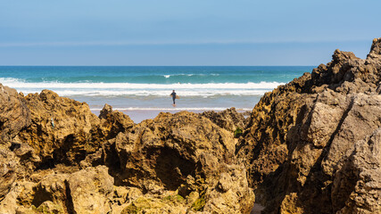 Rock formations in front of Liencres beach on a sunny summer day, Spain.