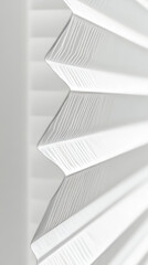 Obraz premium White pleated blinds creating abstract zig zag pattern. Subtle lines and shadows form a modern textured background.