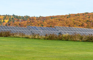 Rows of solar panels in a hilly landscape in autumn
