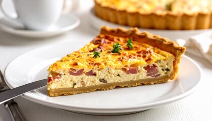 A single slice of savory quiche is presented on a white plate, ready to be enjoyed.
