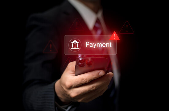Online payment fraud warning during mobile transaction as man uses credit card and smartphone for digital banking, facing potential fraud, phishing, and cybersecurity threats in financial transactions