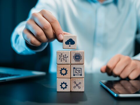 Hand stacking wooden cubes with technology icons artificial intelligence cloud computing - Powered by Adobe