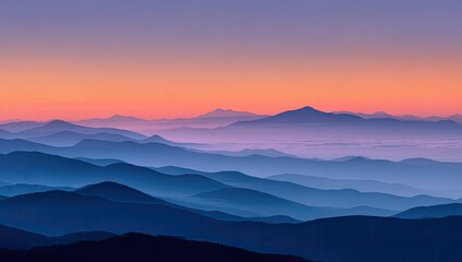 Serene sunrise over layered, hazy mountain ranges, exhibiting a gradient of blue and purple hues in the sky and deepening blues in the distant mountains