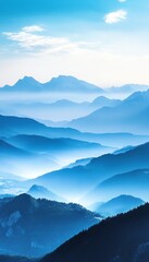 Fototapeta premium Majestic view of blue-toned mountain layers and misty valleys at dawn under a clear sky.