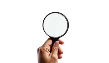 Hand holding magnifying glass isolated on transparent background