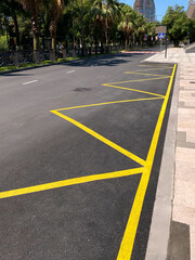 Road sign, yellow markings, public transport stop.
