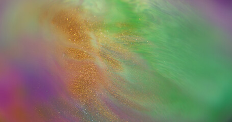 Splash art. Ink background. Defocused green purple yellow colorful liquid shiny neon golden stains...