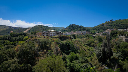 Panoramic view of Tropea emerging from the green hills of Calabria, Southern Italy, under a clear...
