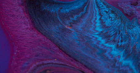 Ink spilling. Color flow. Defocused blue purple liquid ripple pigment chemical water particles...
