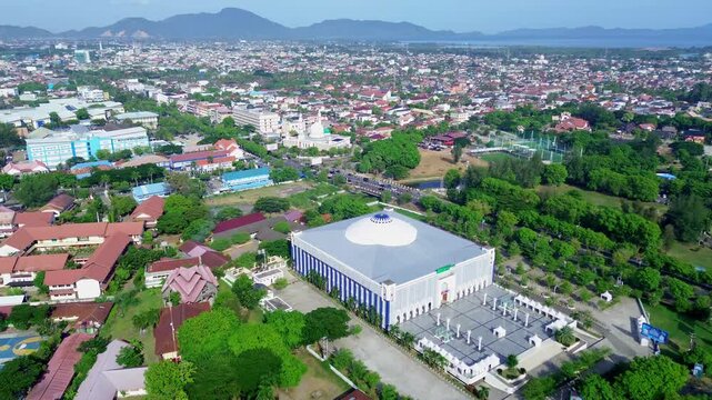 View of the city of Banda Aceh from above using a drone moving forward above the buildings and city streets