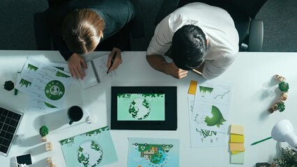 Time lapse of business man presenting sustainable idea to manager by using tablet display ESG environmental social governance. Manager working together planning to use a clean energy. Alimentation.