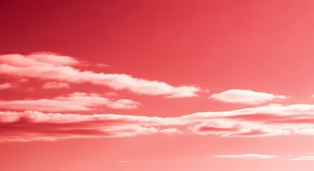 A view of a pink sky with white clouds scattered across the horizon during the daytime hours outdoors