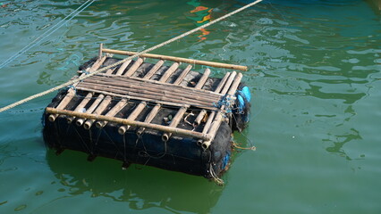 old bamboo raft on the water