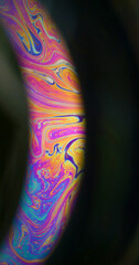 Rainbow oil. Paint mix. Multicolor round arch gasoline liquid blend pigment black background....