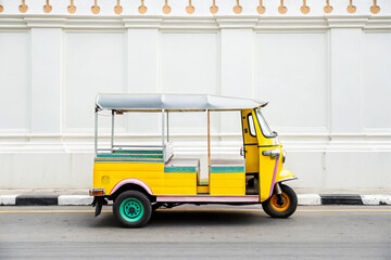Yellow Tuk Parked on Quiet Bangko Street three wheeled vehicle