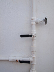 copper pipes and stopcocks painted white