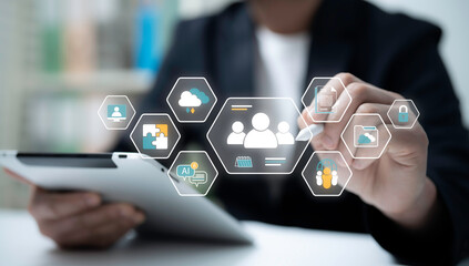Businessman using stylus and tablet interacting with digital team management system showing AI chat...