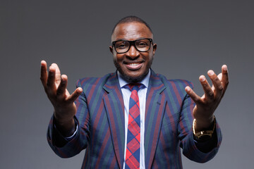 Confident Successful African Businessman in Suit Smiling with Open Arms, Leadership and Achievement