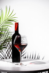 Celebrating the allure of non-alcoholic red wine with a stylish glass and elegant bottle on a chic...