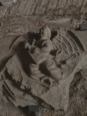 A detailed sand sculpture of an angel playing music, showcasing ephemeral art and craftsmanship.