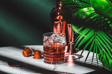 Summer Cold Caramel Coffee alcoholic cocktail drink with vodka, espresso and ice. Green background,...