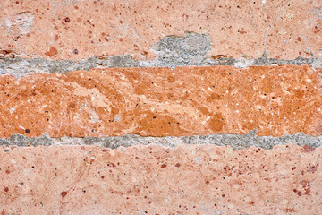 Weathered red brick wall texture with crumbling mortar, creating a rustic and aged background.