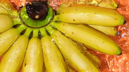 Bunch of mini baby bananas in a water splash top view - Powered by Adobe